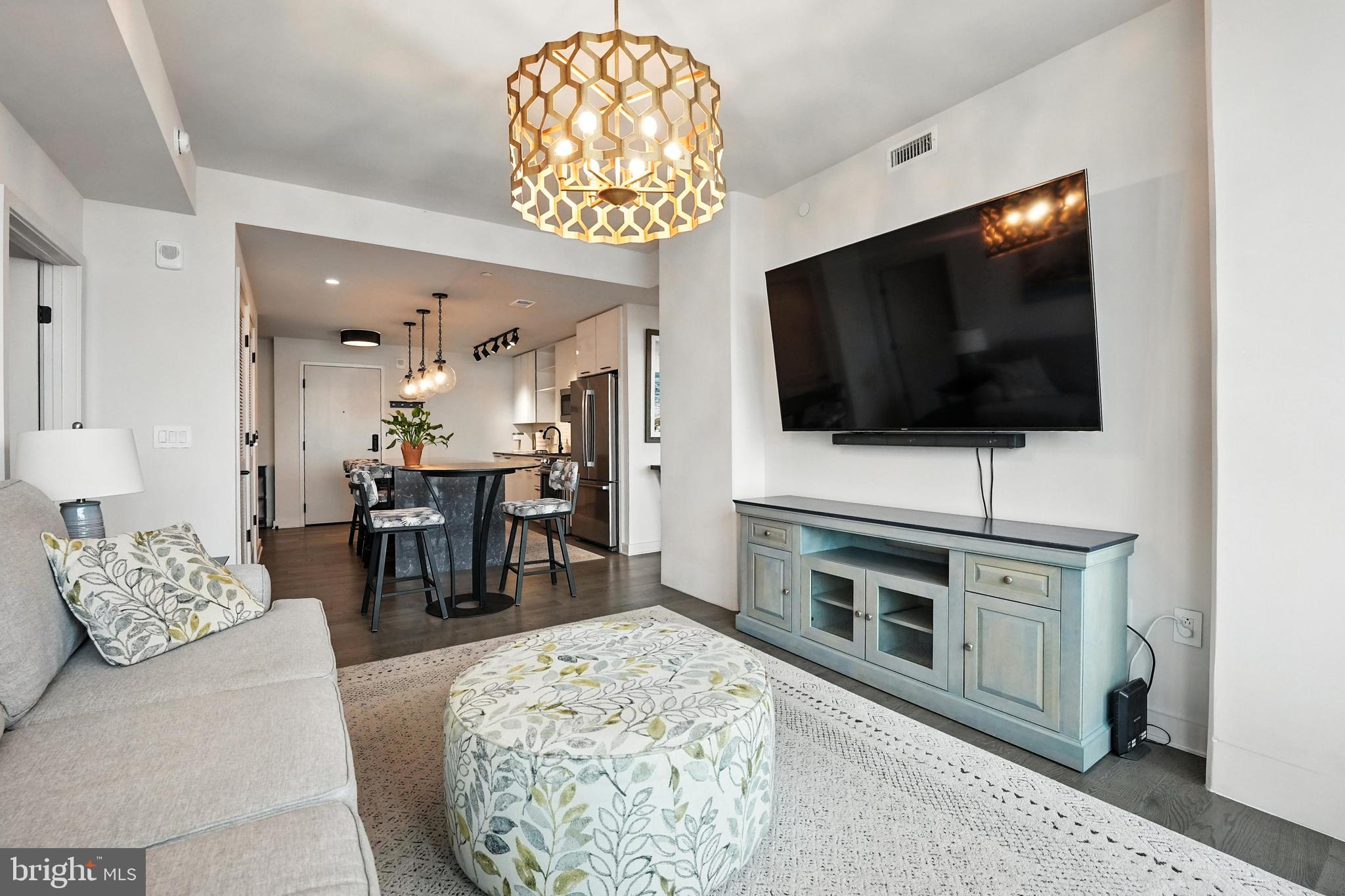 70 N Street Southeast, Unit N913 Washington, DC 20003 - Photo 10 of 77 a living room with furniture and a flat screen tv