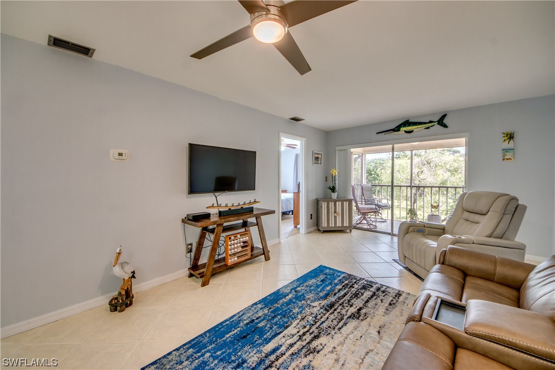 1100 Pondella Road, Unit 814 Cape Coral, FL 33909 - Photo 11 of 36 a living room with furniture and a flat screen tv