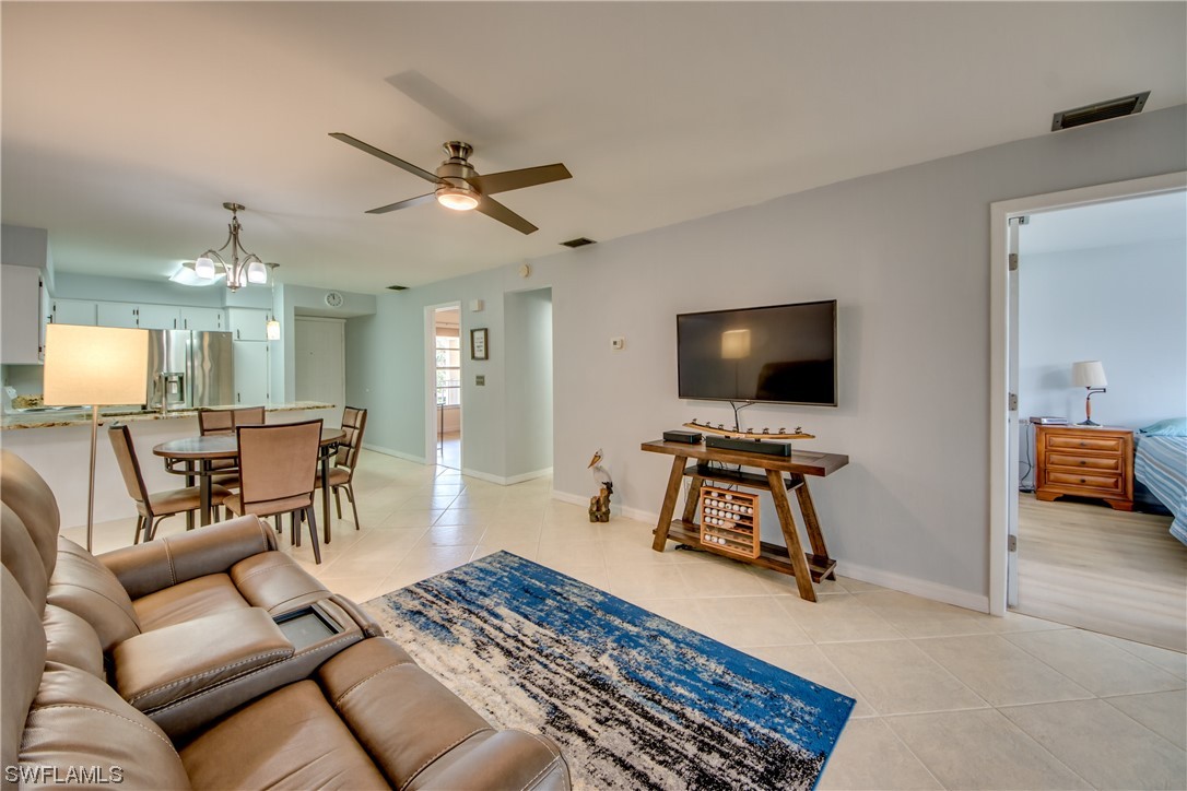 1100 Pondella Road, Unit 814 Cape Coral, FL 33909 - Photo 14 of 36 a living room with furniture and a flat screen tv