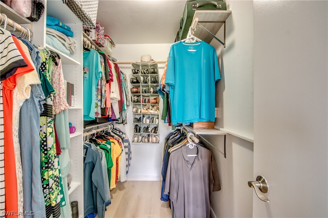 1100 Pondella Road, Unit 814 Cape Coral, FL 33909 - Photo 19 of 36 a view of walk in closet with clothes