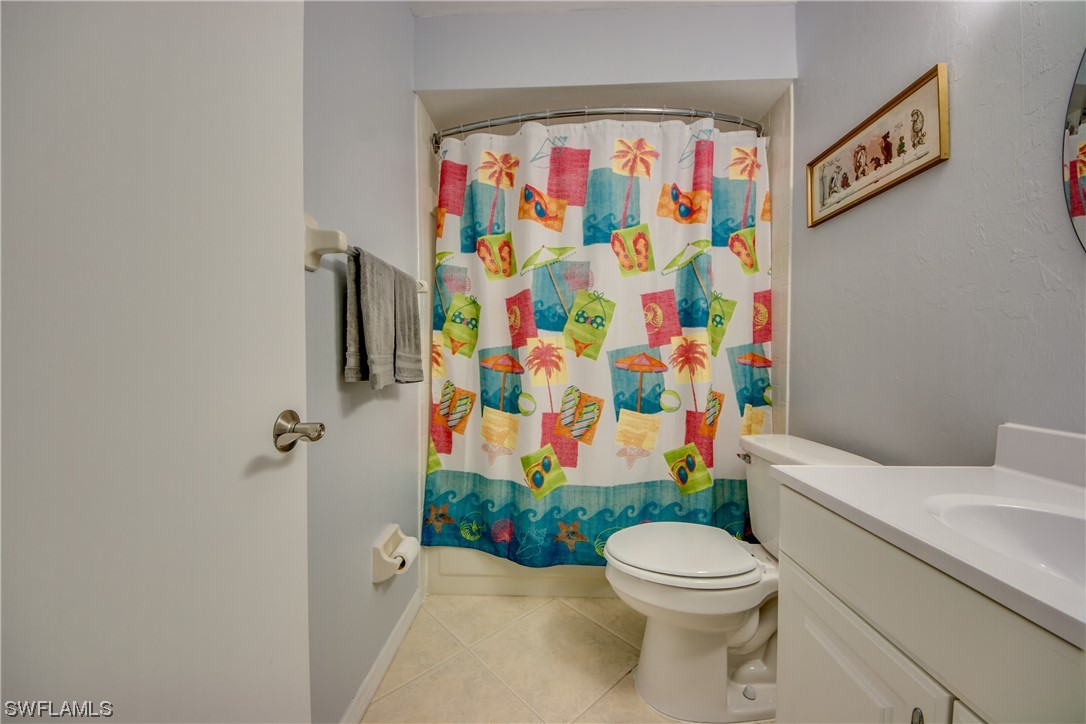 1100 Pondella Road, Unit 814 Cape Coral, FL 33909 - Photo 21 of 36 a white toilet sitting next to a shower curtain