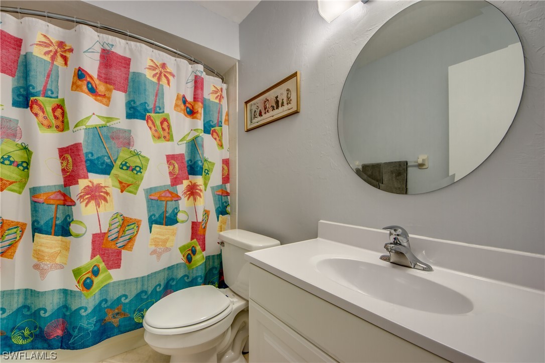 1100 Pondella Road, Unit 814 Cape Coral, FL 33909 - Photo 22 of 36 a white toilet sitting next to a bathroom sink