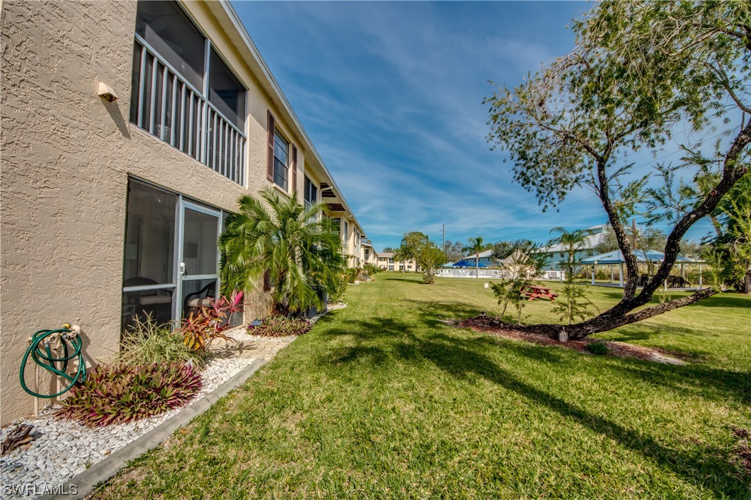 1100 Pondella Road, Unit 814 Cape Coral, FL 33909 - Photo 27 of 36 a view of a backyard with plants and a small pool