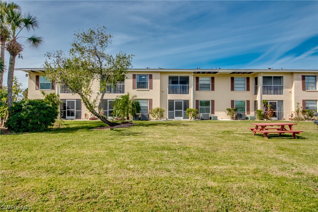1100 Pondella Road, Unit 814 Cape Coral, FL 33909 - Photo 29 of 36 a view of a house with a swimming pool and a yard