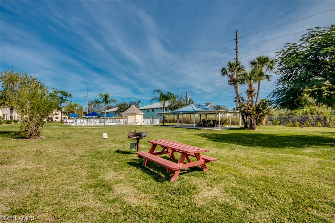 1100 Pondella Road, Unit 814 Cape Coral, FL 33909 - Photo 30 of 36 a swimming pool with outdoor seating and yard