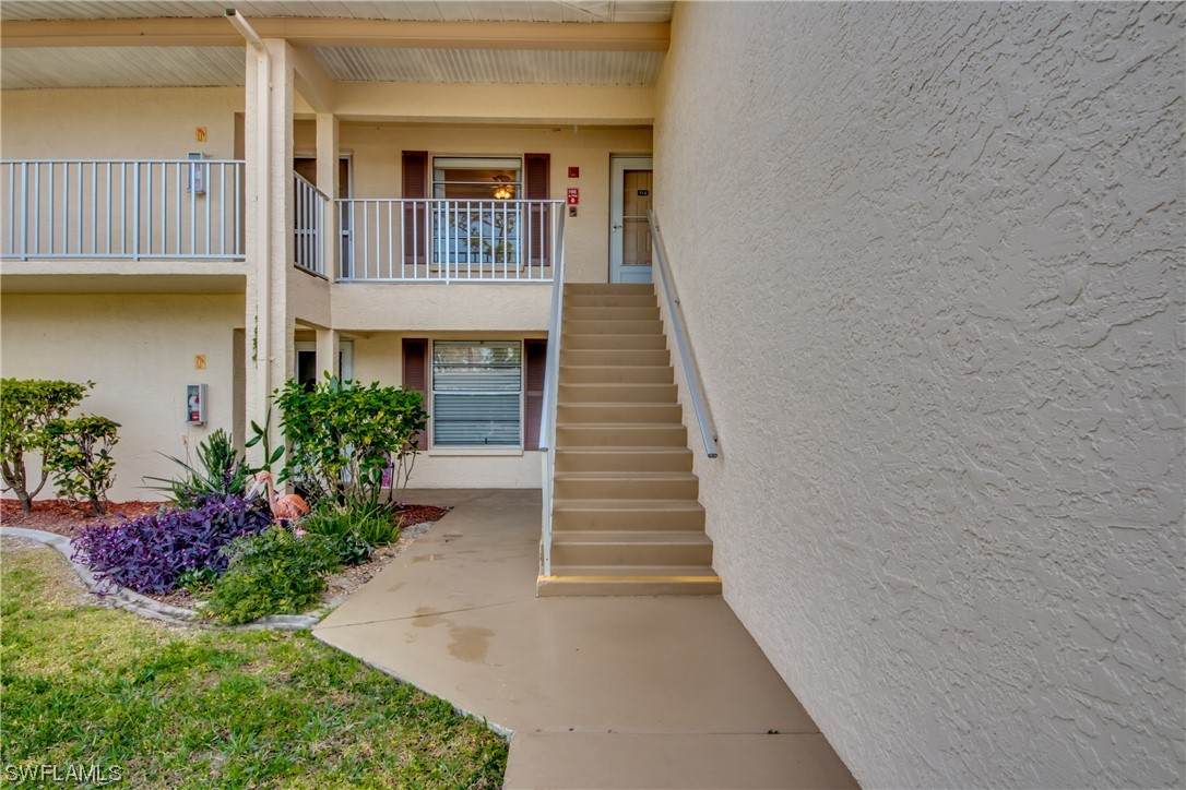 1100 Pondella Road, Unit 814 Cape Coral, FL 33909 - Photo 3 of 36 a view of a house with entryway and flower plants