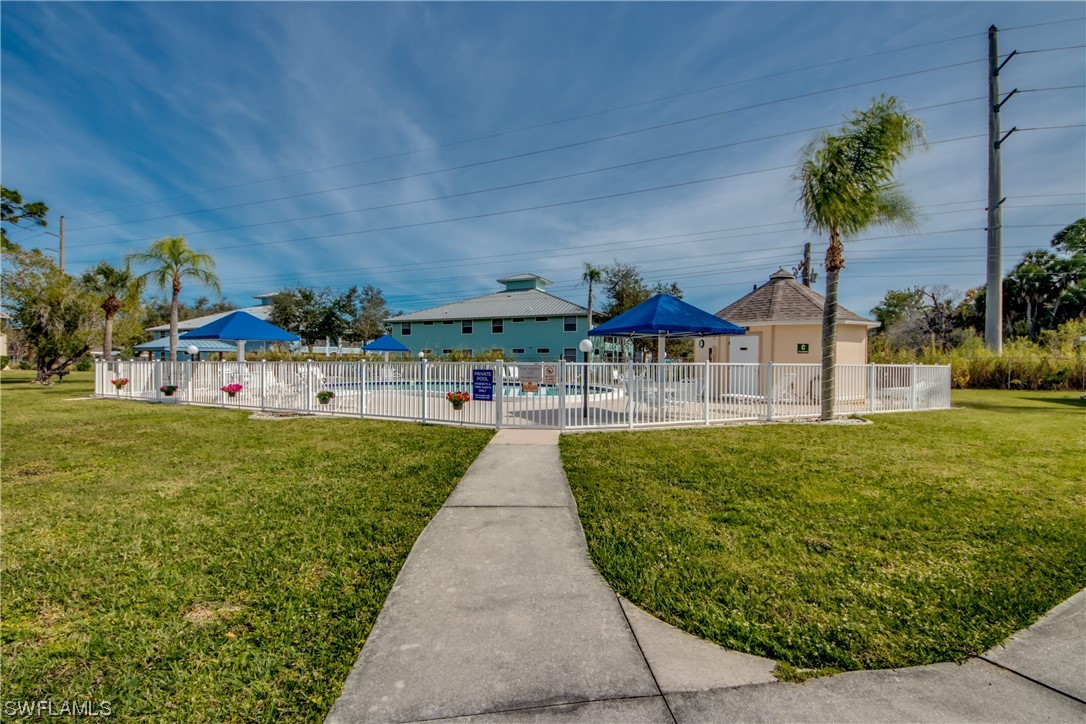 1100 Pondella Road, Unit 814 Cape Coral, FL 33909 - Photo 33 of 36 a view of swimming pool with outdoor seating and green space