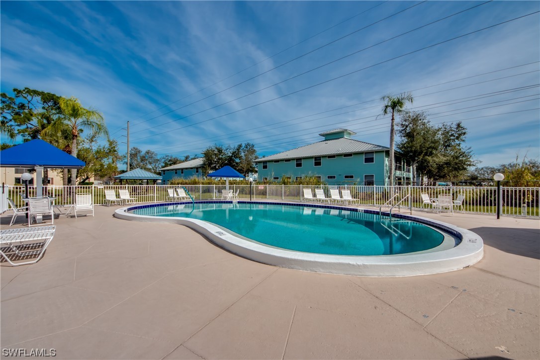 1100 Pondella Road, Unit 814 Cape Coral, FL 33909 - Photo 34 of 36 a swimming pool with outdoor seating and yard