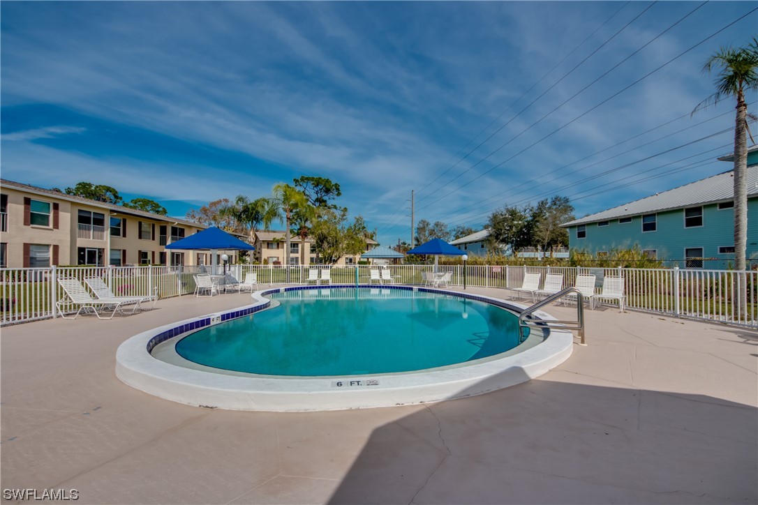 1100 Pondella Road, Unit 814 Cape Coral, FL 33909 - Photo 35 of 36 a swimming pool with outdoor seating and yard
