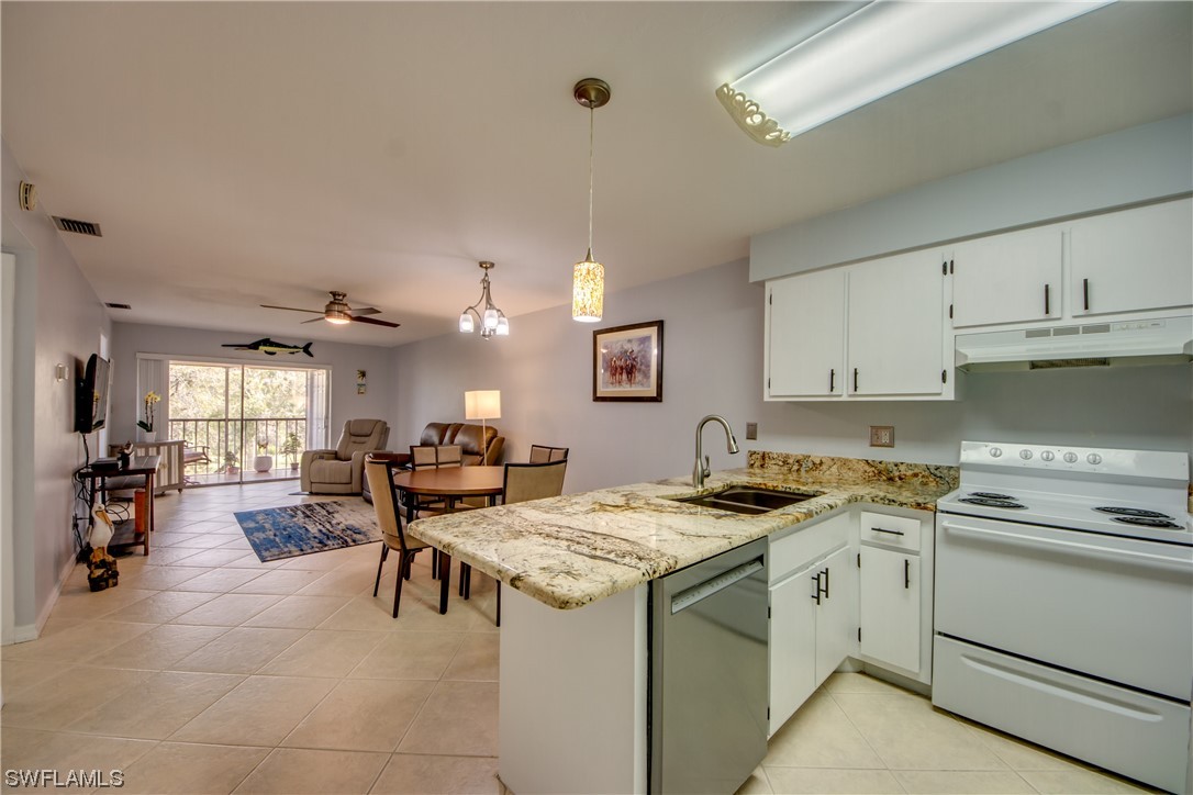 1100 Pondella Road, Unit 814 Cape Coral, FL 33909 - Photo 4 of 36 a kitchen that has a lot of cabinets in it and appliances