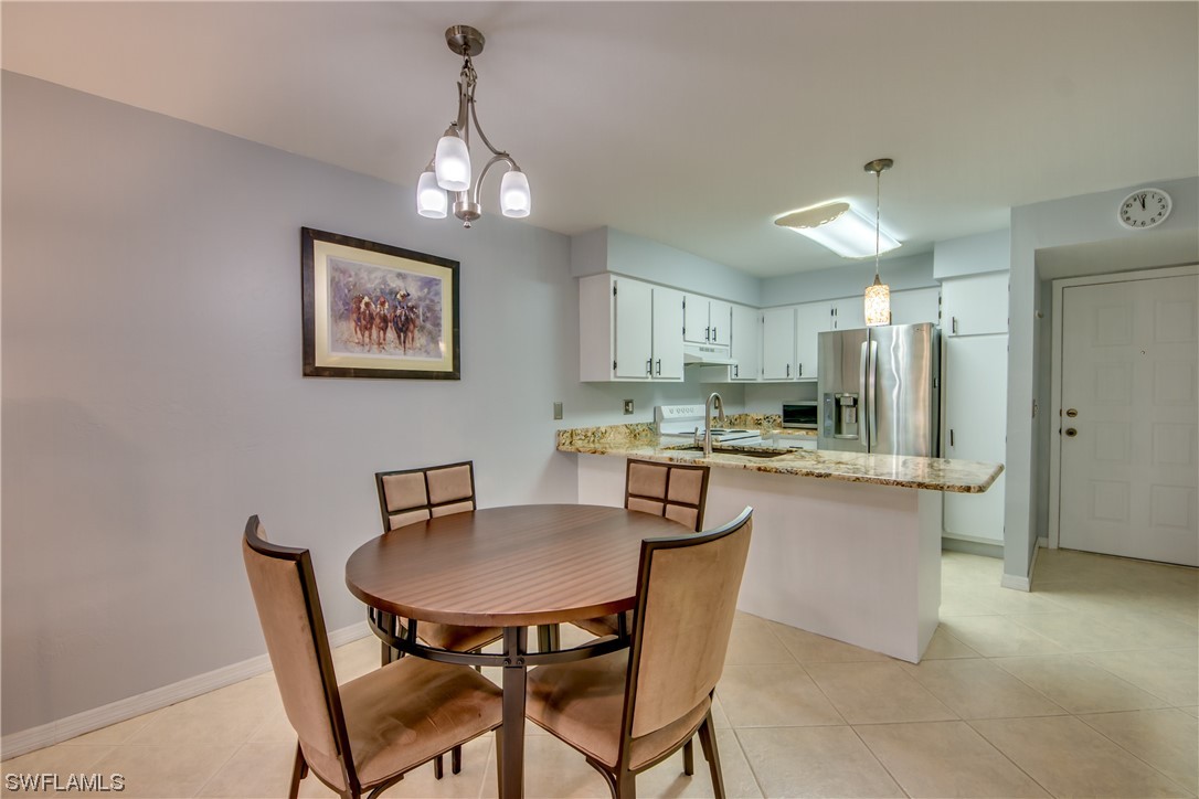 1100 Pondella Road, Unit 814 Cape Coral, FL 33909 - Photo 10 of 36 a dining room with stainless steel appliances a table and chairs