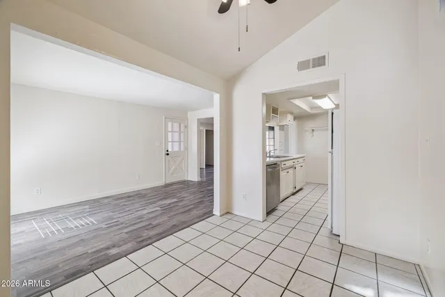 a view of a hallway with wooden floor and a living room