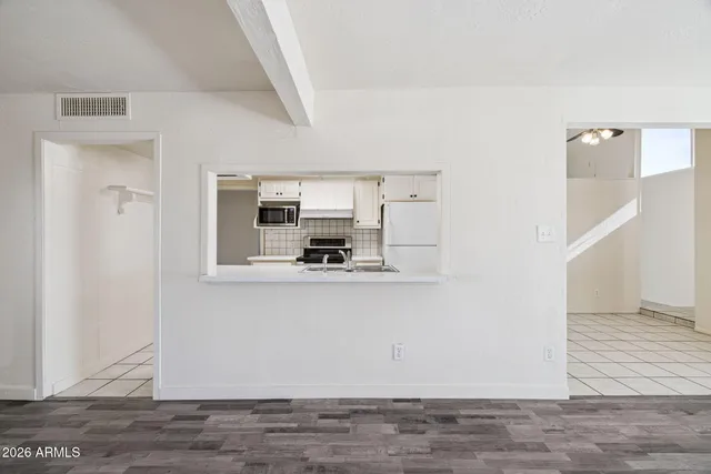 a view of a kitchen from the hallway
