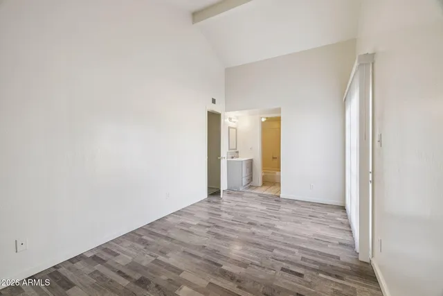 a view of an empty room with wooden floor