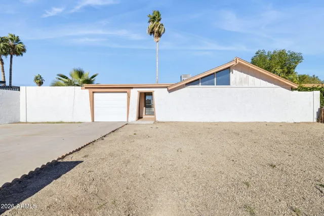 a front view of a house with a road