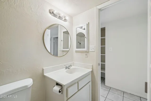 a bathroom with a sink mirror and toilet
