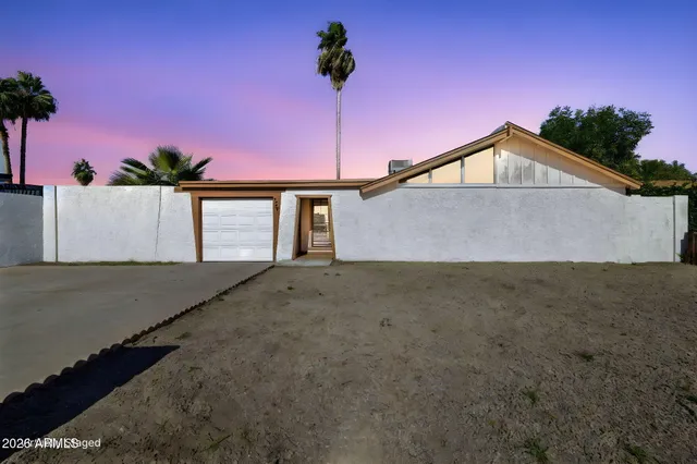 a front view of a house with a street
