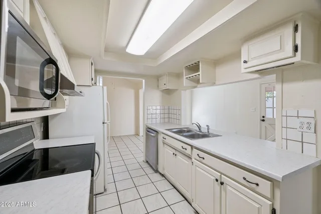 a kitchen with a sink and cabinets