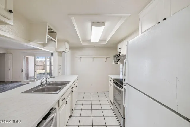 a kitchen that has a sink stainless steel appliances a counter space and cabinets