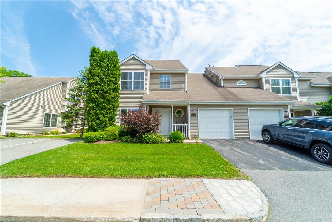 106 Sparrow Ridge Road, Unit 21V Carmel, NY 10512 - Photo 1 of 1 a front view of a house with a garden and plants