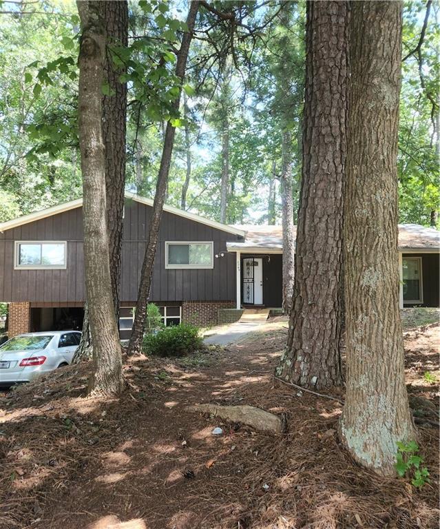 a view of a house with a tree in front of it
