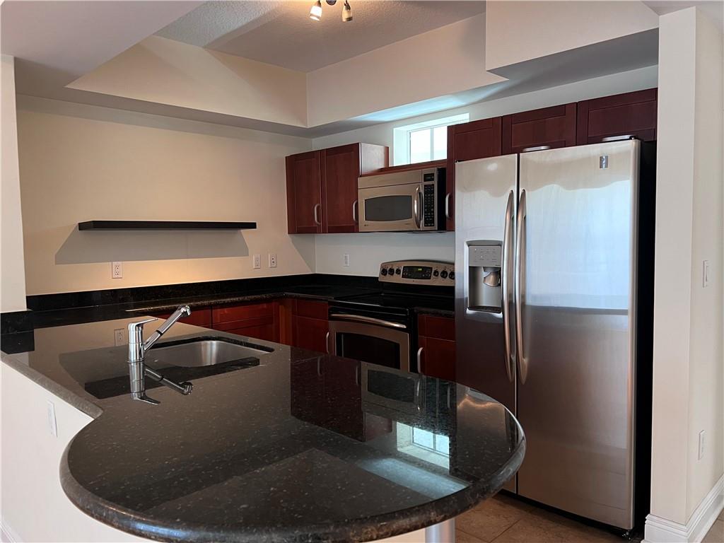 a kitchen with a sink and stainless steel appliances