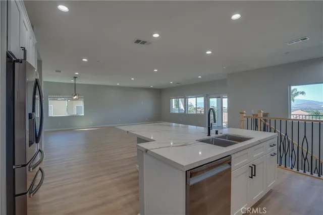 a kitchen with a sink appliances and cabinets