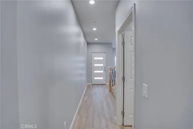 a view of a hallway with wooden floor