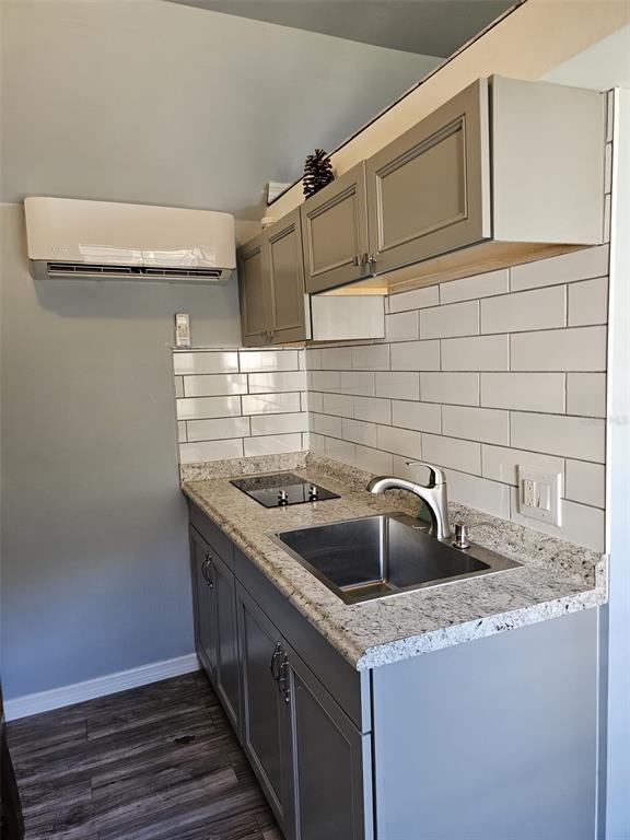 20805 Sheldon Street Orlando, FL 32833 - Photo 12 of 18 a kitchen with granite countertop a sink and a stove