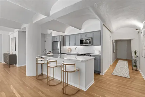 a kitchen with a sink cabinets and wooden floor