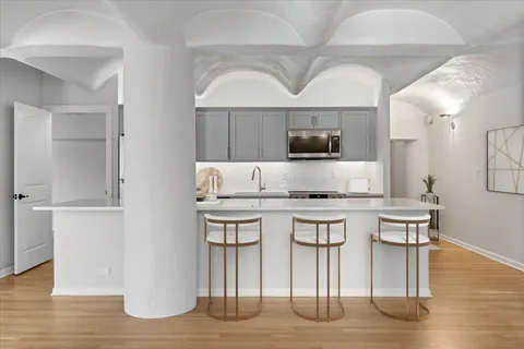 a kitchen with stainless steel appliances a sink stove and microwave