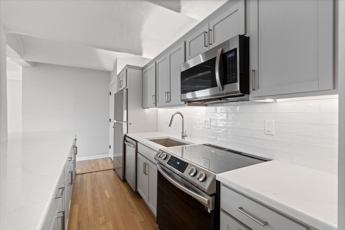 345 North Canal Street, Unit 608 Chicago, IL 60606 - Photo 6 of 27 a kitchen with stainless steel appliances a sink stove and microwave
