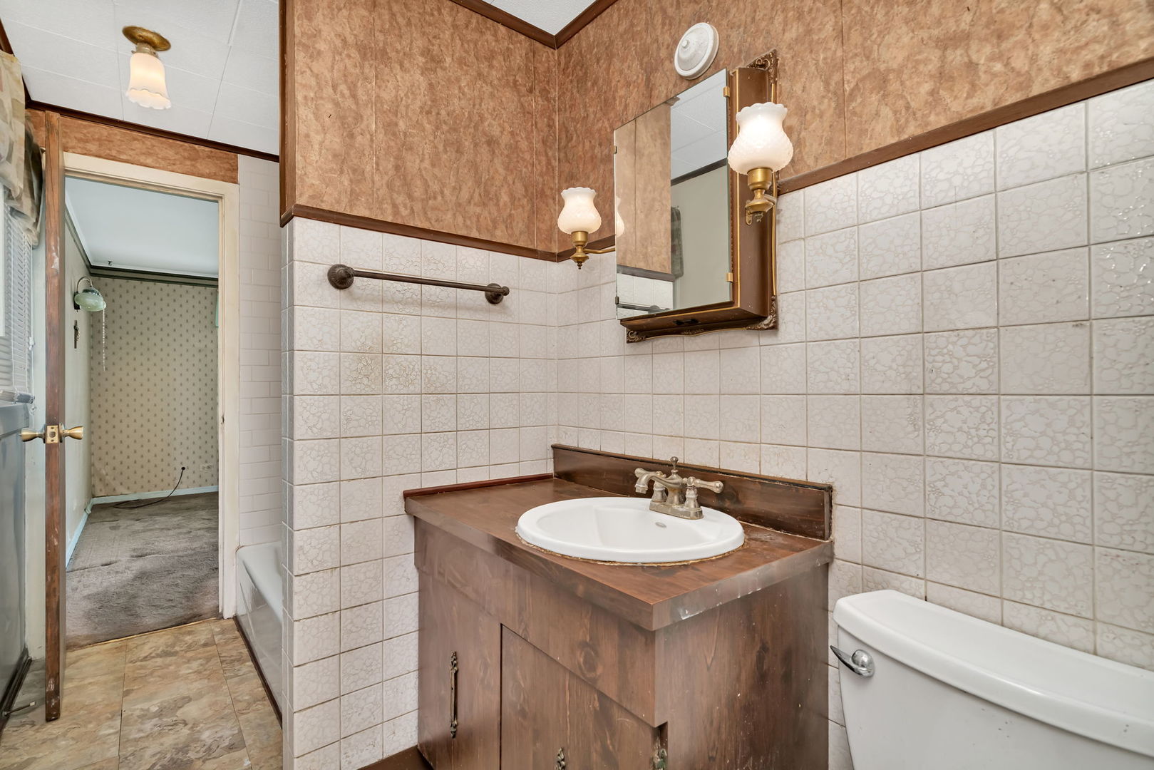 8955 South Corcoran Road Hometown, IL 60456 - Photo 12 of 20 a bathroom with a sink a toilet and mirror