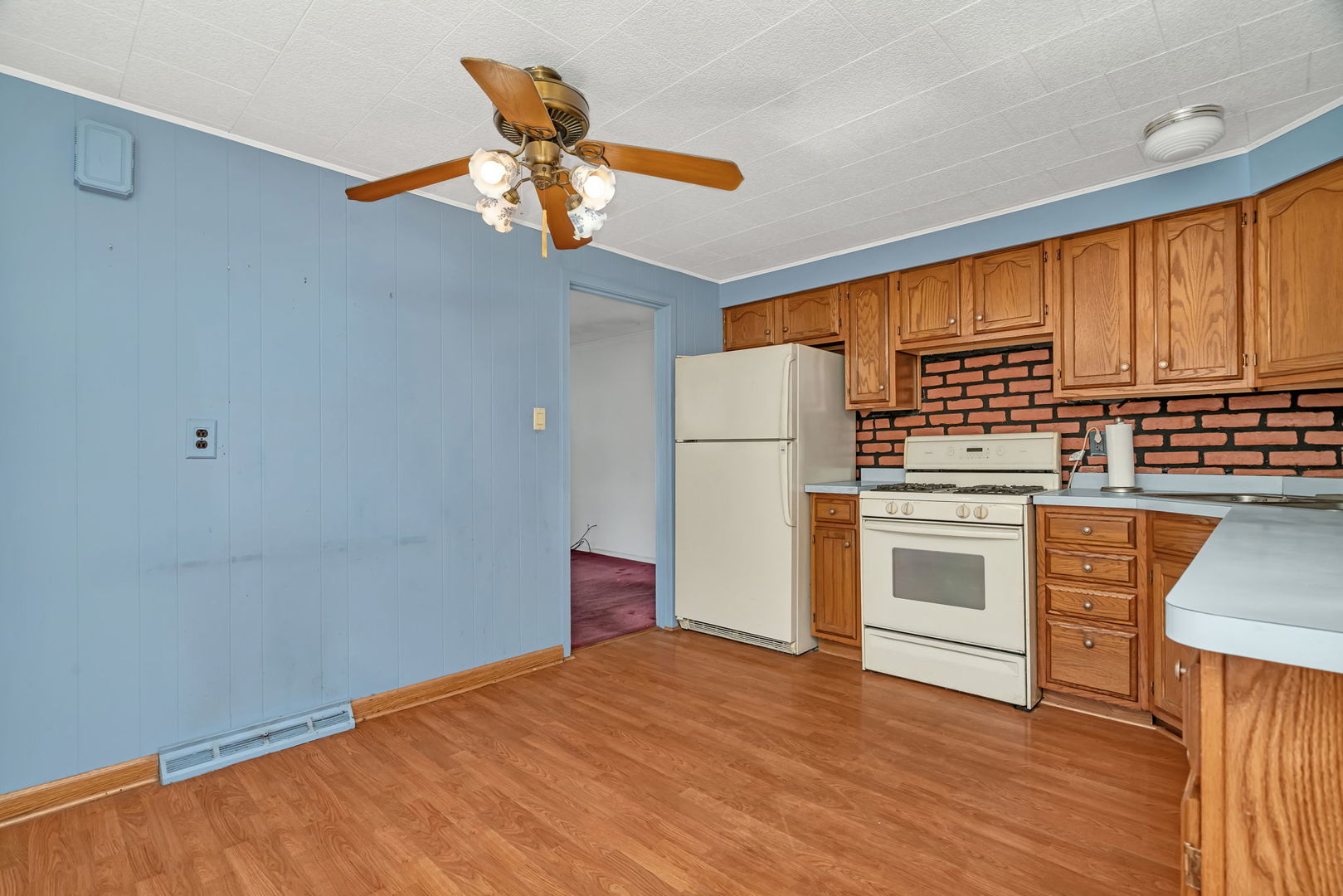 8955 South Corcoran Road Hometown, IL 60456 - Photo 8 of 20 a kitchen with granite countertop a refrigerator a stove a sink cabinets and wooden floor