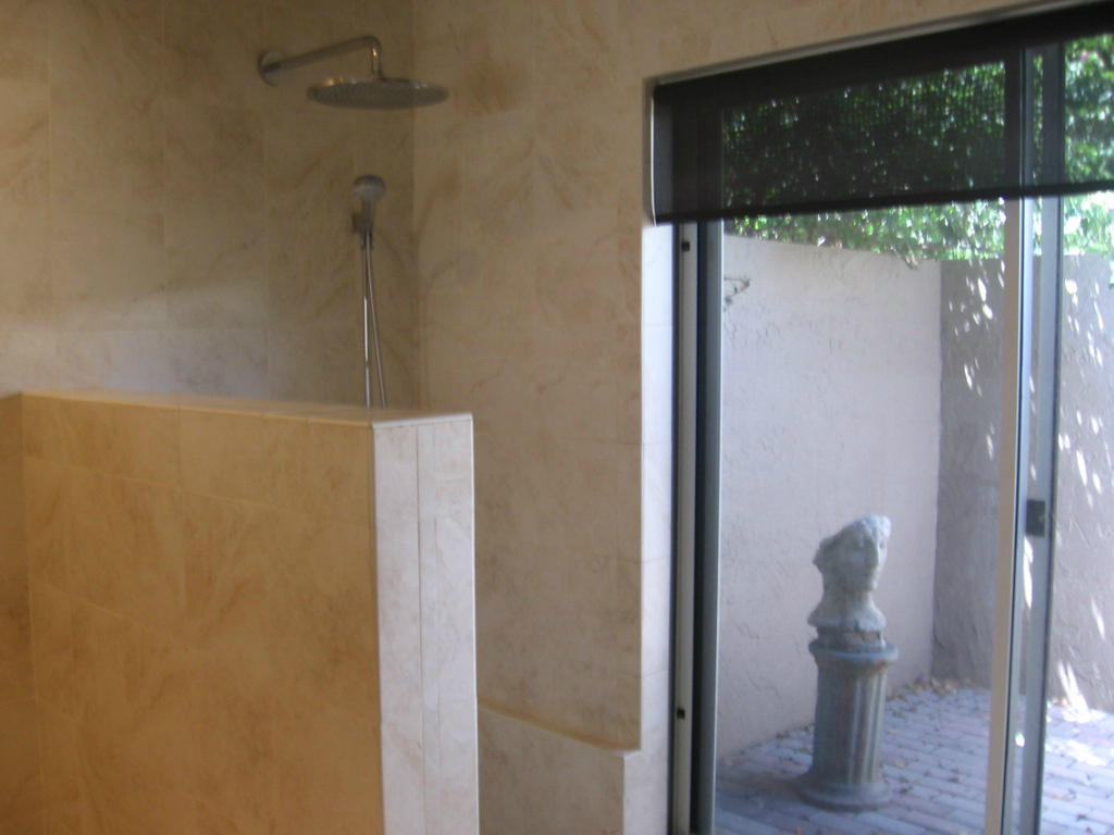 245 Northwest 70th Street Boca Raton, FL 33487 - Photo 15 of 39 a bathroom with a glass shower door