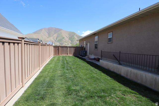 1055 North 1000 East Mapleton, UT 84664 - Photo 99 of 112 Expansive green lawn bounded by a privacy fence and a stucco exterior