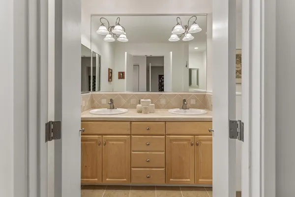 a bathroom with a sink a tub and a mirror