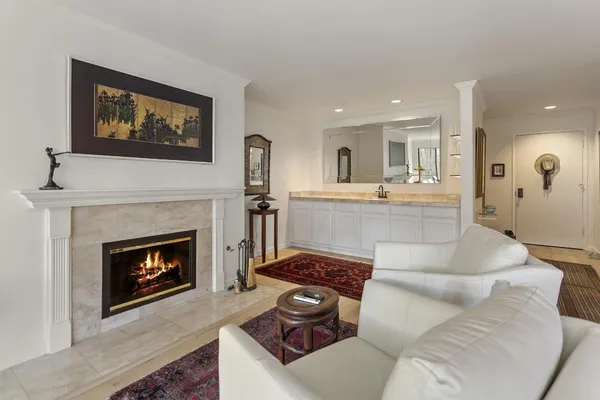 a living room with furniture a clock and a fireplace