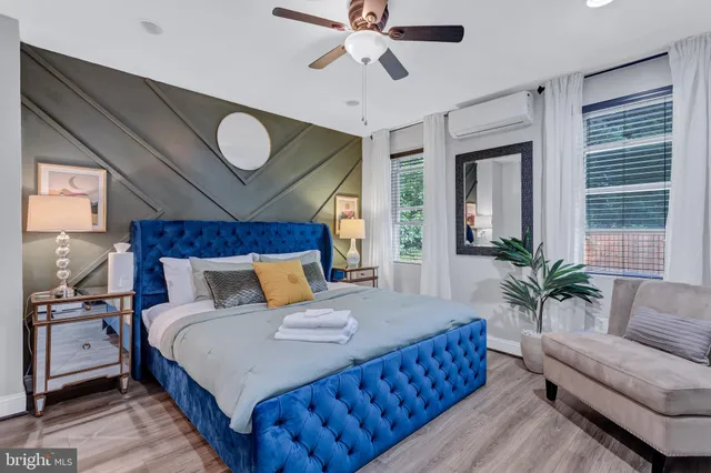 a bedroom with a large bed and a chandelier