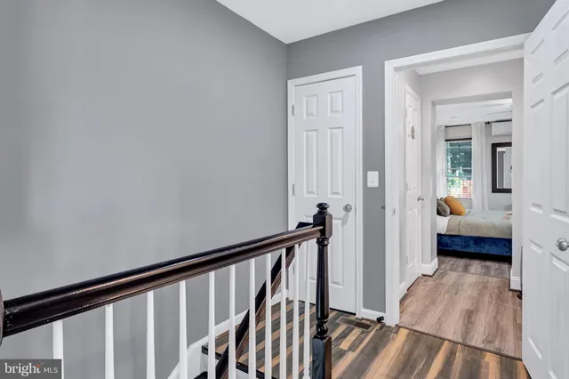 a view of a hallway with a livingroom and furniture