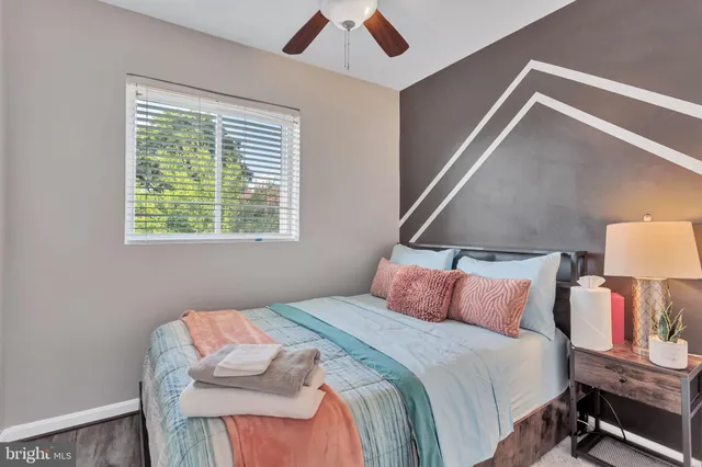 a bedroom with a bed and a night stand