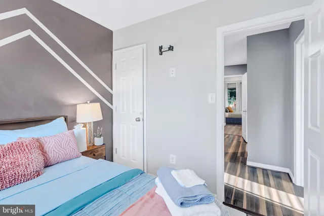 a living room with furniture and a baby crib