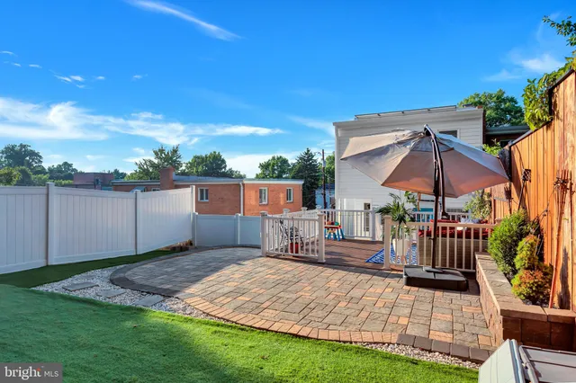 a view of a house with a backyard porch and sitting area