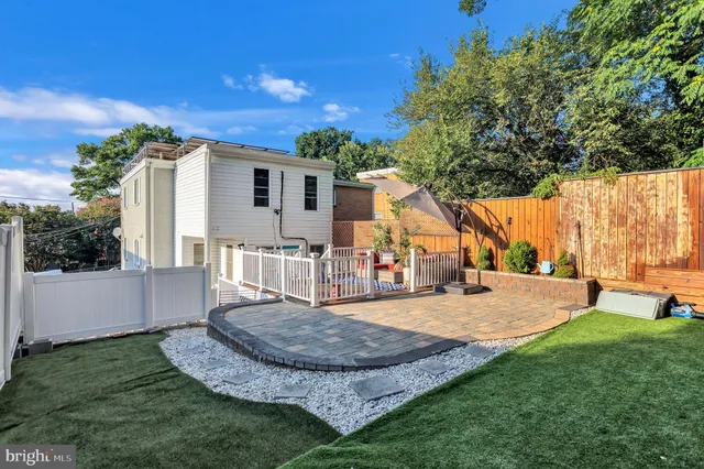 a view of a backyard with wooden fence