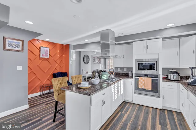 a kitchen with granite countertop lots of counter top space a sink and appliances