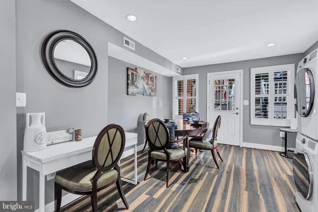 a view of a dining room with furniture and a large window
