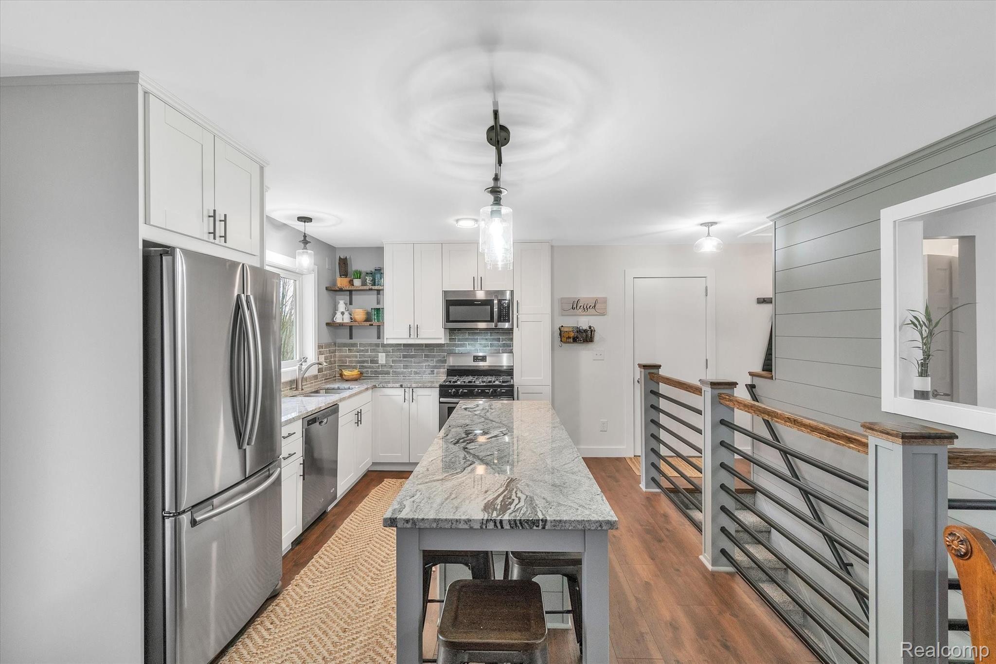 680 Murray Hill Road Highland, MI 48357 - Photo 10 of 45 New kitchen with granite, island counter and stainless appliances