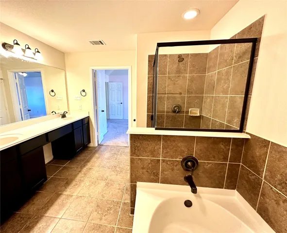 a bathroom with a double vanity sink a mirror and shower