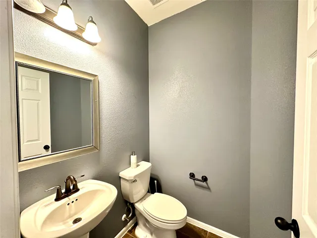 a kitchen with stainless steel appliances granite countertop a sink and a refrigerator