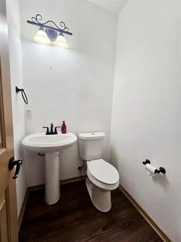 a bathroom with a sink toilet and a mirror